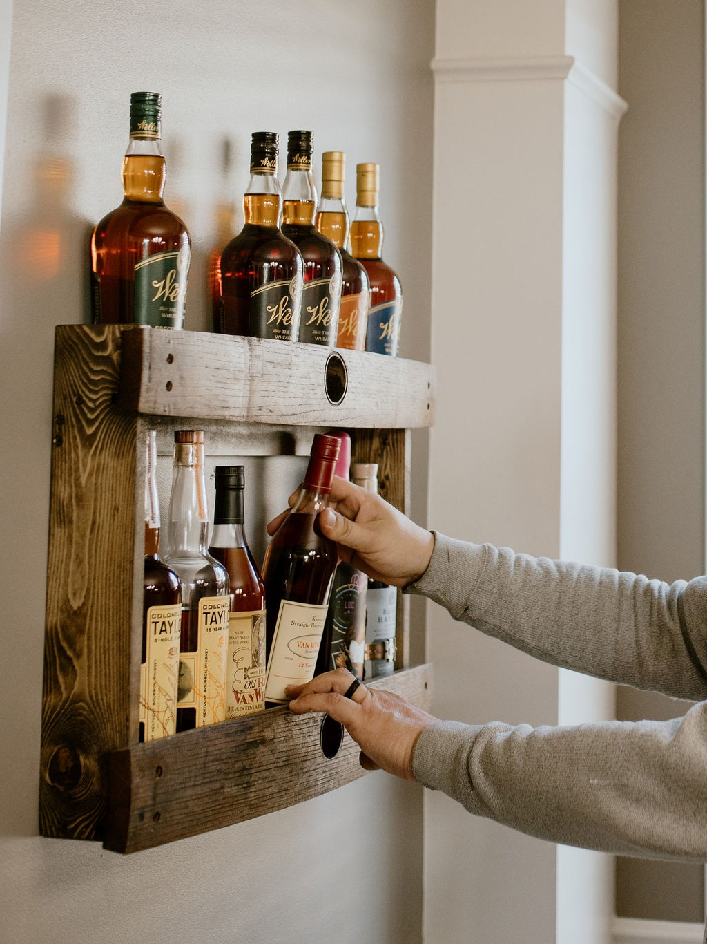 Dark walnut bourbon whiskey liquor barrel stave shelf, wood bottle display cabinet, wall mount, easy installation, staged with bourbon bottles